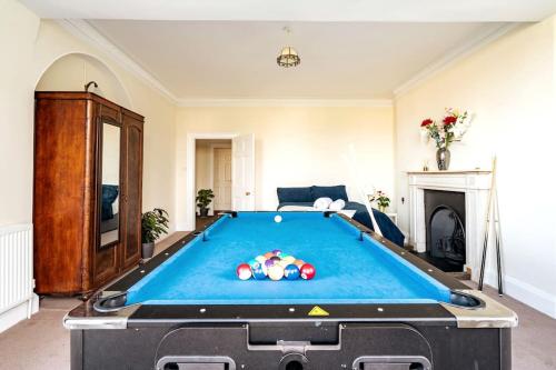 a pool table in the middle of a living room at Perfect Family & Friends Home, Free Parking Security Onsite in Reading