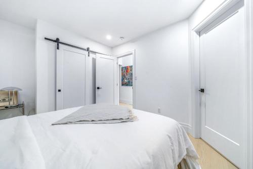 a white bedroom with a bed with white walls at The Wellington General in Wellington
