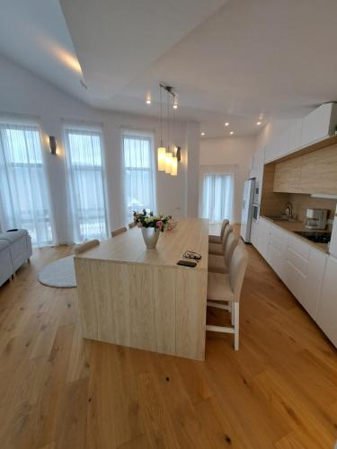 een keuken en een woonkamer met een grote houten tafel bij The Rock in Sinaia
