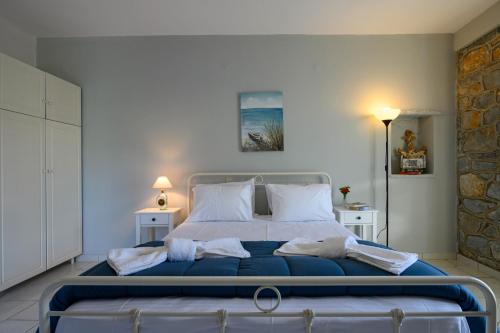 a bedroom with a large bed with towels on it at Μαϊστράλι in Kotrónion