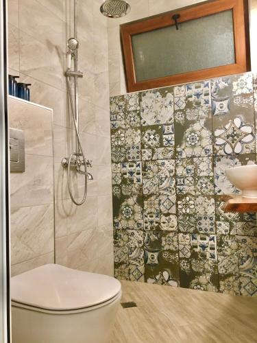 a bathroom with a toilet and a sink at Dimitrovi Guesthouse - Peaceful Stay near Beach with Garden, Sarafovo in Burgas