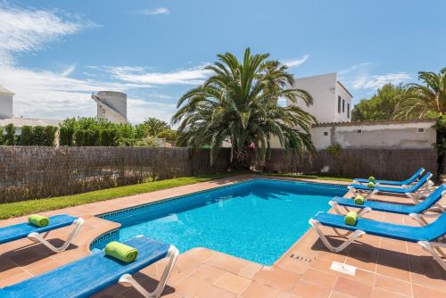 a swimming pool with two lounge chairs and a swimming pool at Villa Laurax in Son Carrio