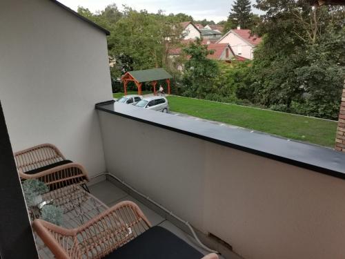 a balcony with two chairs and a gazebo at Apartment Novi Park Bulatovic in Vrdnik