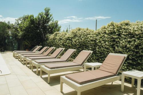 a row of lounge chairs sitting on a patio at Deluxe apartment Marghareta in Dubrovnik