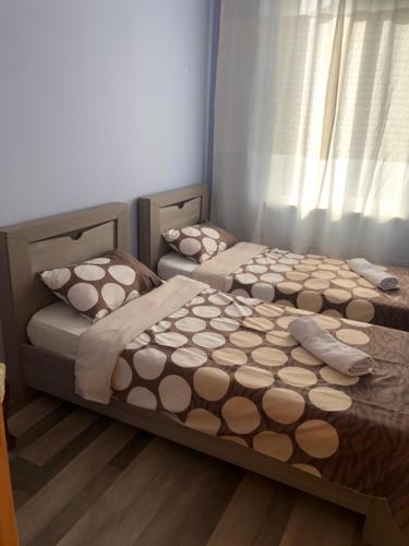 two beds sitting next to each other in a bedroom at DreamLand Lagodekhi & Wine Cellar in Lagodekhi