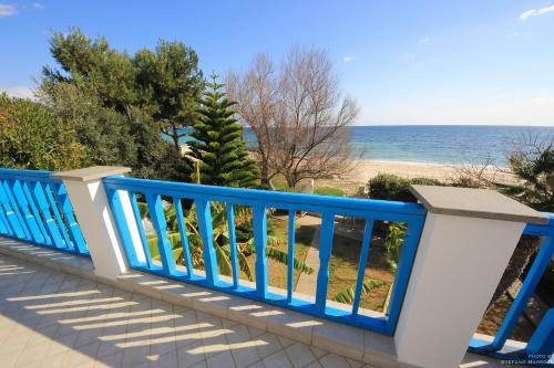 a blue railing on a balcony overlooking the beach at La Casa Sulla Spiaggia in Flumini di Quartu