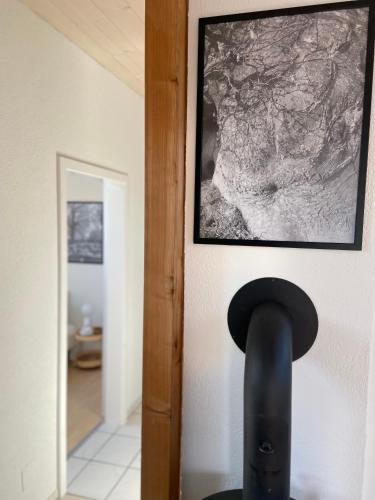 a black object on a wall with a picture at Naturnahe Familienwohnung in Rüschegg-Graben