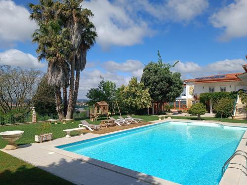 a swimming pool in the yard of a house at Casa Grande in Golpilheira