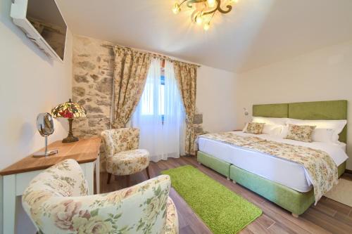 a bedroom with a bed and a desk and a chair at Luxury Villa Ive With Heated Pool, Finnish Sauna, Infrared Sauna, Pet Friendly in Krk