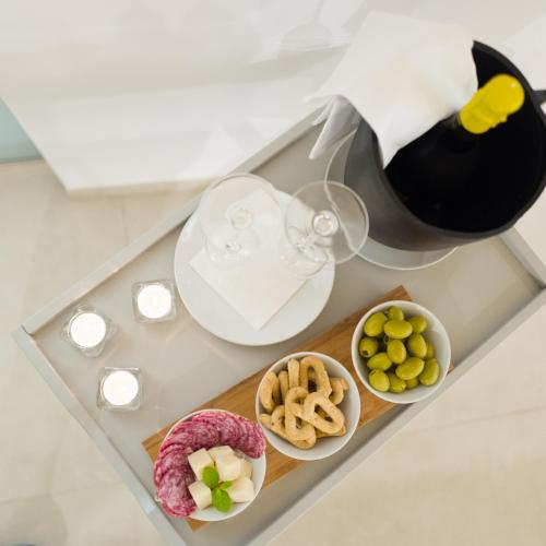 a table with some food and a bottle of wine at Casa Minerva - Suite e Relax in Gioia del Colle