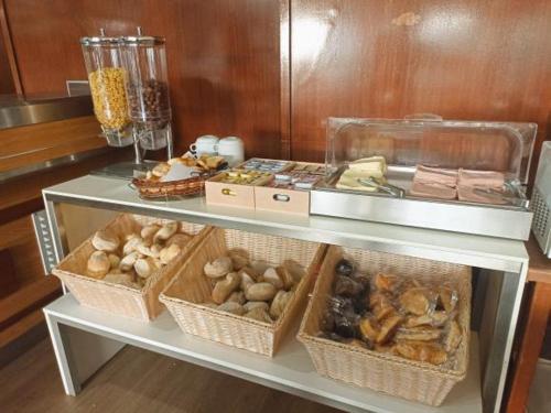 a shelf filled with lots of different types of food at Residencial Dona Teresa in Maia