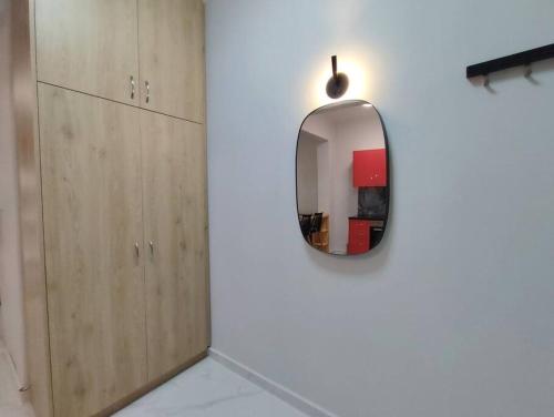 a mirror hanging on a wall in a room at Άνετο στούντιο στο κέντρο in Athens