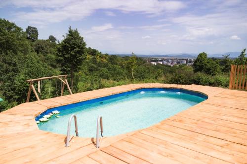 a swimming pool on top of a wooden deck at Madre Natura Glamping in Ulcinj