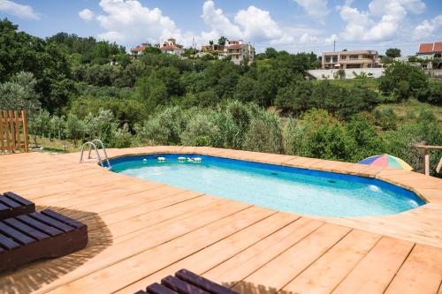 a swimming pool on a wooden deck with a swimming poolvisor at Madre Natura Glamping in Ulcinj