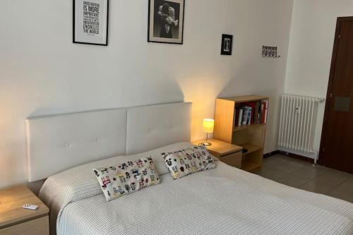 ein Schlafzimmer mit einem Bett mit zwei Kissen darauf in der Unterkunft Ampio e luminoso bilocale in Turin