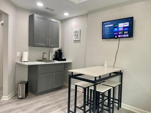 a kitchen with a counter and a table and a tv at Unwind in Winder in Winder