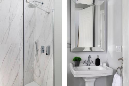 a bathroom with a shower and a sink and a mirror at San Buenaventura Apartment 13 in Seville