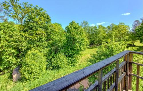 a wooden bridge over a field with trees at 1 Bedroom Nice Apartment In Ljungbyhed in Ljungbyhed