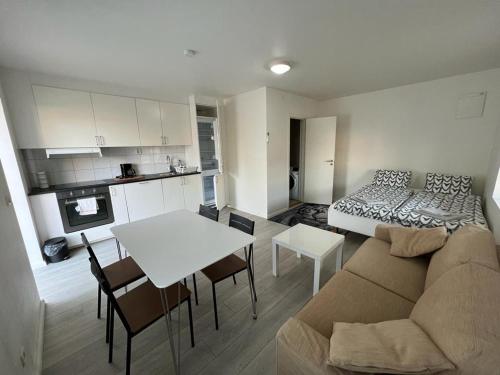 a living room with a couch and a table at Furnished apartment close to the beach in Abbekås