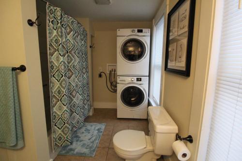 a bathroom with a washing machine and a washer and dryer at Fabulous Barre Apts! in Barre