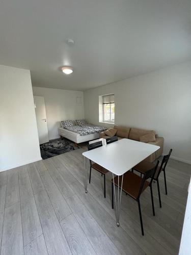 a living room with a table and a bed at Furnished apartment close to the beach in Abbekås