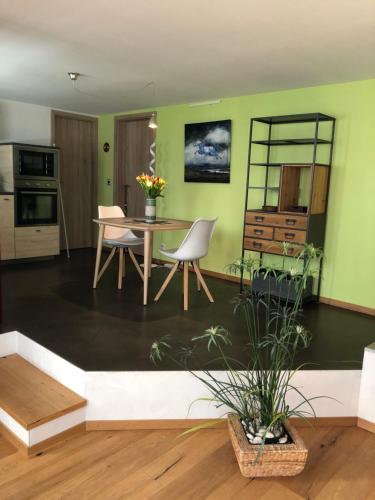 a living room with green walls and a table and chairs at Olympia by the lake in Lausanne