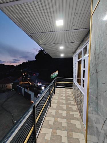 a balcony with a view of the water at Alpine Valley Homestay in Shimla
