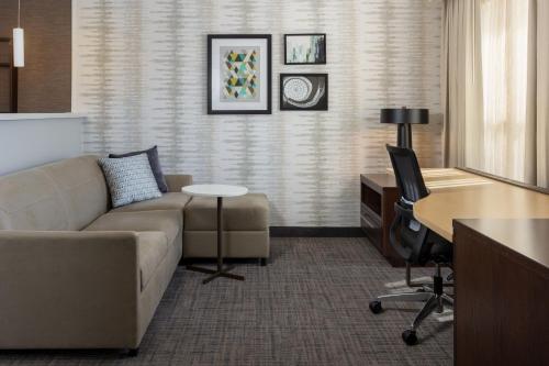 a living room with a couch and a desk at Residence Inn by Marriott Kansas City at The Legends in Kansas City