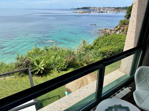 a view of the ocean from a balcony at Hostal Casa Aurita Adults Only in Sanxenxo