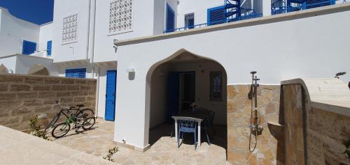 a hallway of a white building with a table at La Dimora del Salento in Torre Lapillo