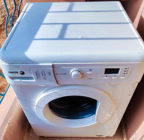 a white washing machine with its door open at Your new home in Oujda