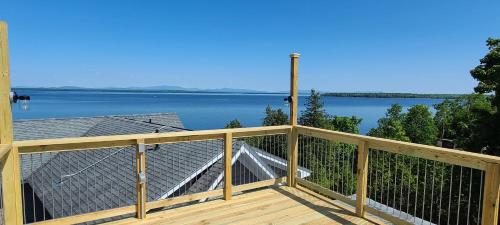 a deck with a view of the water at Loza house adirondack skydeck unit lake front in Plattsburgh