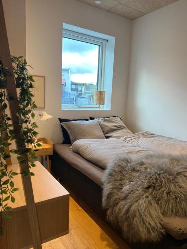 a bed in a room with a window at Atlantic Jewel in Tórshavn