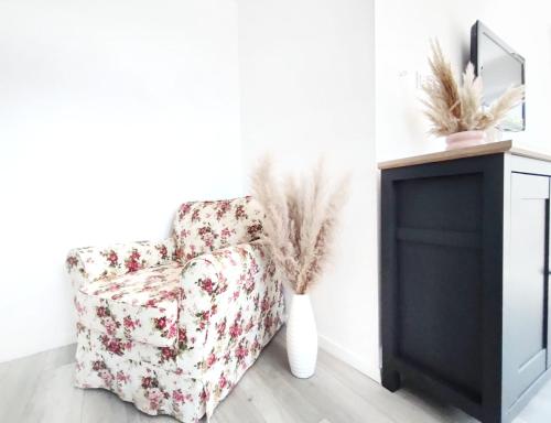 a living room with a chair and a fireplace at APARTAMENTY Charzykowy in Charzykowy
