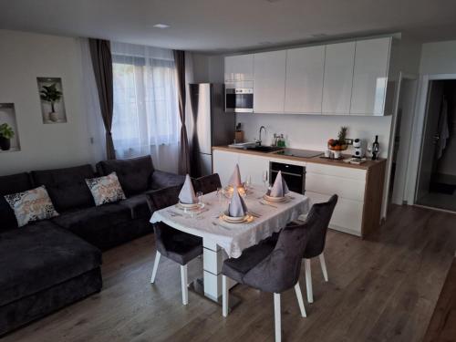 a living room with a table with chairs and a couch at Ivana&Luka-Put luke 1, Brela in Brela