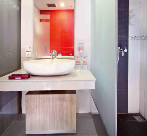 a bathroom with a sink and a shower at favehotel Cimanuk Garut in Garut