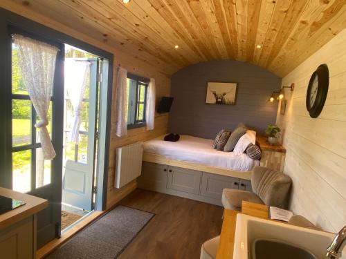 a bedroom with a bed in a tiny house at Oakies Farm Stays in Llandovery