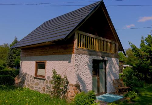 a small stone house with a black roof at Chata Morgana in Bolków