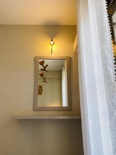 a mirror on a wall next to a shelf at Harmony Seaside Pelion in Platanias