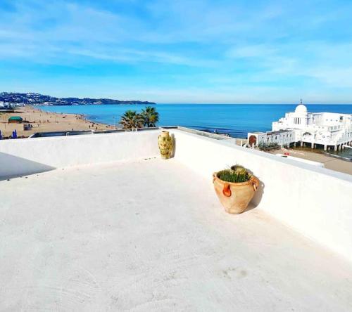 a view of the ocean from the roof of a building at Agréable maison traditionnel au cœur de la Marsa in Douar el Hafey