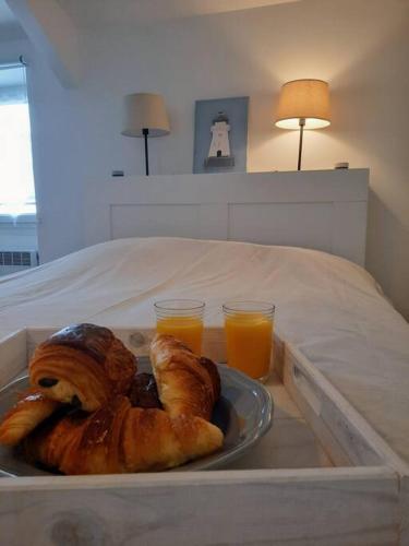a tray of bread and two glasses of orange juice at La Palme de Retz in Pornic