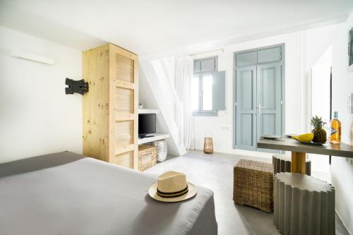 a bedroom with a bed with a hat on it at K&K Residence @Mykonos Town in Mikonos