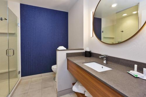 a bathroom with a sink and a mirror at Fairfield by Marriott Inn & Suites Knoxville Airport Alcoa in Alcoa