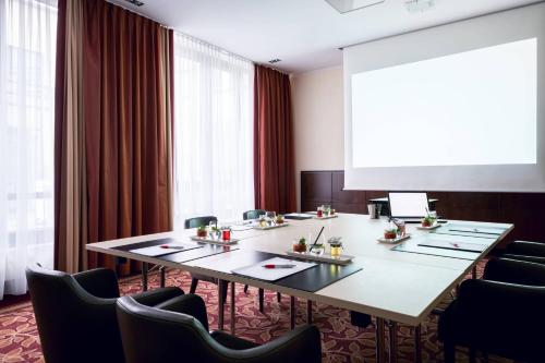 a conference room with a long table and chairs at Munich Airport Marriott Hotel in Freising