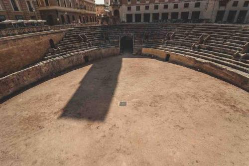 an empty amphitheater with a shadow of a building at Eleutheria beach villa by the beach in Torre Chianca