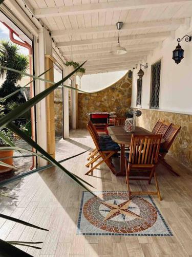 a dining room with a table and chairs at Eleutheria beach villa by the beach in Torre Chianca