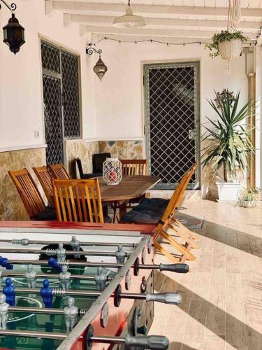 a living room with a table and chairs at Eleutheria beach villa by the beach in Torre Chianca
