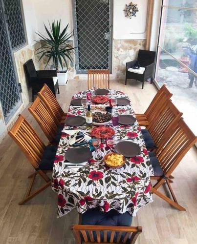 a table with a table cloth on it with chairs at Eleutheria beach villa by the beach in Torre Chianca