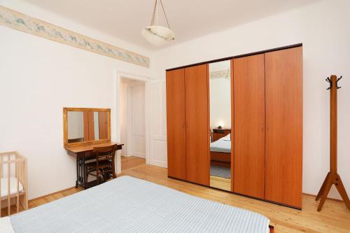 ein Schlafzimmer mit einem großen Holzschrank und einem Spiegel in der Unterkunft Casa Santo e Albina Rabac in Rabac