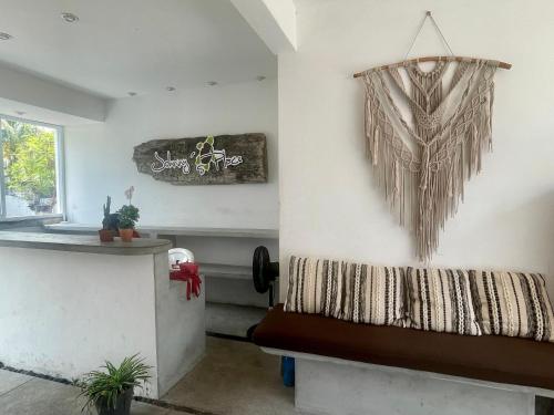 a room with a bench and a chandelier on the wall at Johnnys Place Hotel in Monterrico
